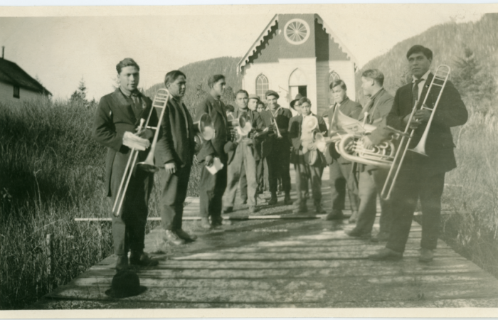 Brass and drum band in front of a church