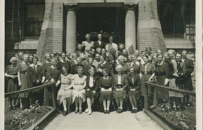 Group of people sitting outside in front of a building