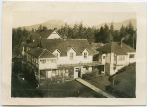 Front of building with path in front and trees in background